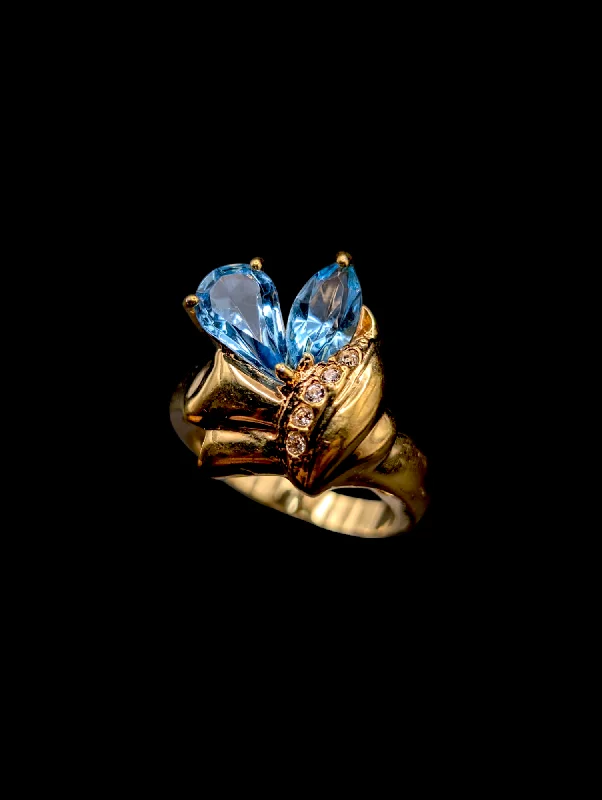 Rings with star sapphire for unique glow -Vintage Simulated Swiss Blue Topaz and Diamond Accent Ruman Gold Toned Costume Ring