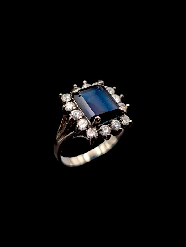 Rings with rainbow moonstone for color play -Vintage Simulated Royal Blue Sapphire and Simulated Diamonds Halo Silver Toned Costume Ring